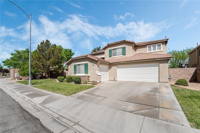 view of front facade with a tile roof, concrete driveway, an attached garage, a front yard, and stucco siding