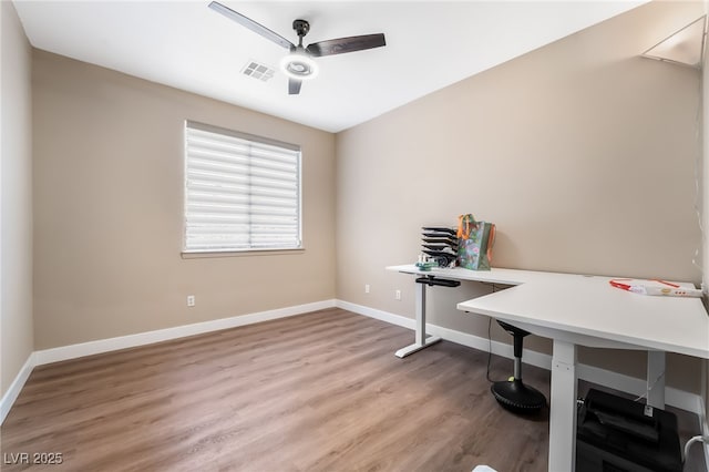 home office with ceiling fan, baseboards, wood finished floors, and visible vents