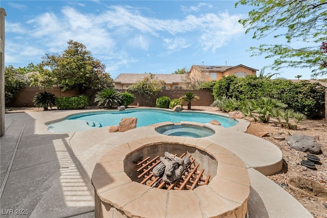 view of swimming pool featuring a fenced backyard, a pool with connected hot tub, and a patio