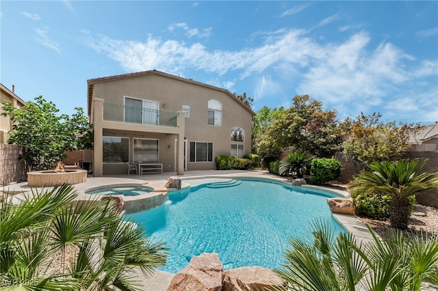 view of swimming pool featuring fence, a patio area, and a pool with connected hot tub