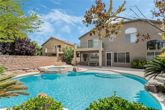 view of pool with fence, a patio, and a pool with connected hot tub