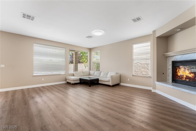 sitting room with baseboards, wood finished floors, and visible vents