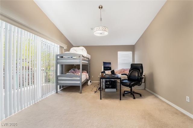 bedroom with vaulted ceiling, carpet floors, and baseboards