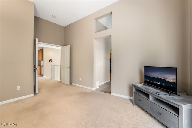 unfurnished living room with light carpet and baseboards
