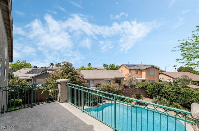 exterior space with a residential view and a fenced in pool