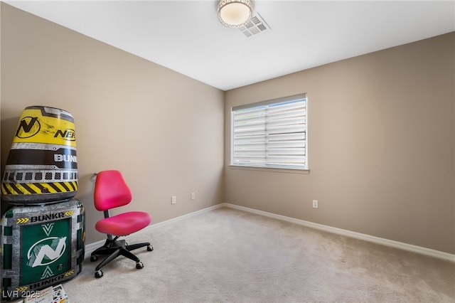 carpeted office space featuring visible vents and baseboards