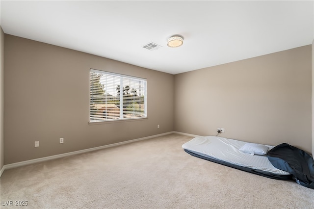 bedroom with light carpet, visible vents, and baseboards