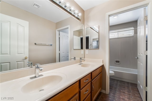 full bathroom featuring visible vents, a sink, double vanity, and toilet