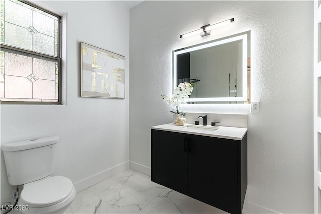 1350 Rossini St, Henderson, NV 89052 - bathroom featuring marble look tile flooring, toilet, vanity, and baseboards