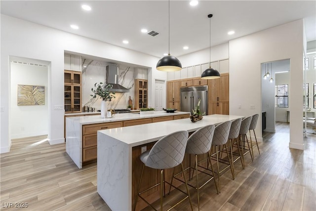 1350 Rossini St, Henderson, NV 89052 - kitchen featuring a spacious island, built in fridge, wall chimney exhaust hood, light wood-type flooring, and recessed lighting
