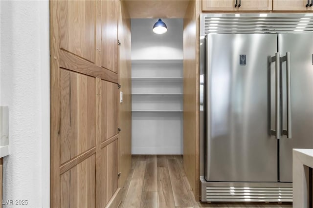 1350 Rossini St, Henderson, NV 89052 - kitchen view of high end fridge, light wood-style floors, and light brown cabinetry