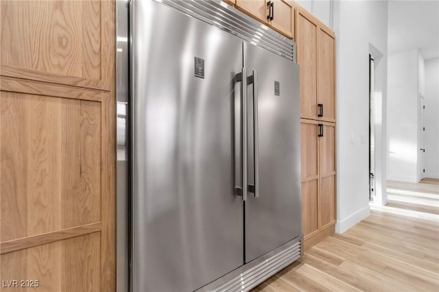 1350 Rossini St, Henderson, NV 89052 - kitchen view of built in refrigerator, light wood-type flooring, baseboards, and light brown cabinetry