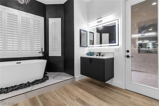 1350 Rossini St, Henderson, NV 89052 - full bath with wood finished floors, a freestanding bath, and vanity