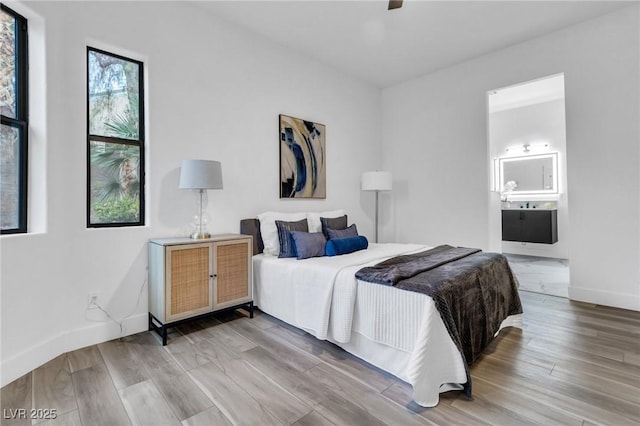 1350 Rossini St, Henderson, NV 89052 - bedroom featuring wood finished floors, baseboards, ensuite bath, a ceiling fan, and a sink