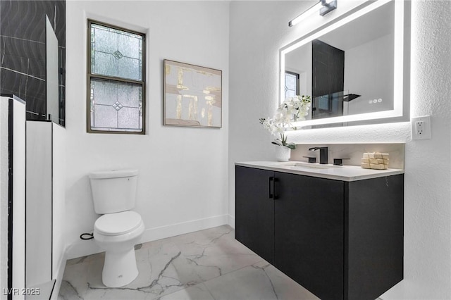 1350 Rossini St, Henderson, NV 89052 - full bathroom featuring marble look tiles, toilet, vanity, and baseboards
