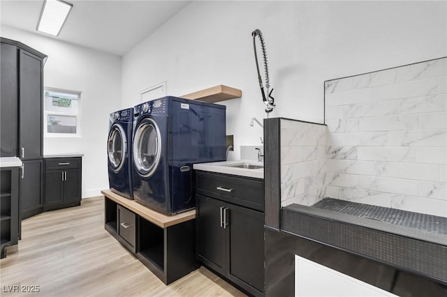 1350 Rossini St, Henderson, NV 89052 - clothes washing area featuring separate washer and dryer, cabinet space, and light wood finished floors