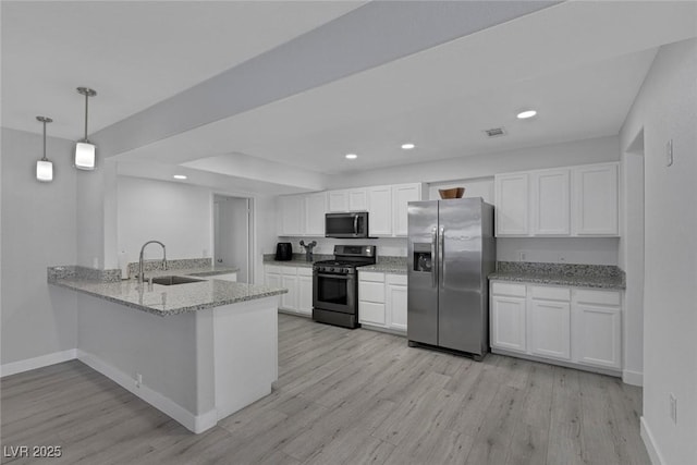 kitchen with white cabinets, recessed lighting, stainless steel appliances, and a sink