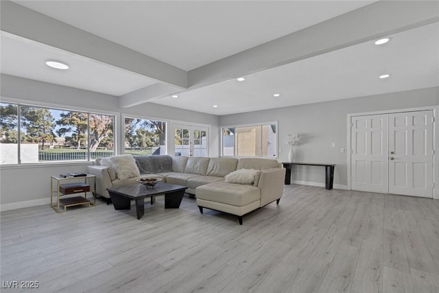 living area featuring light wood finished floors, baseboards, beam ceiling, and recessed lighting