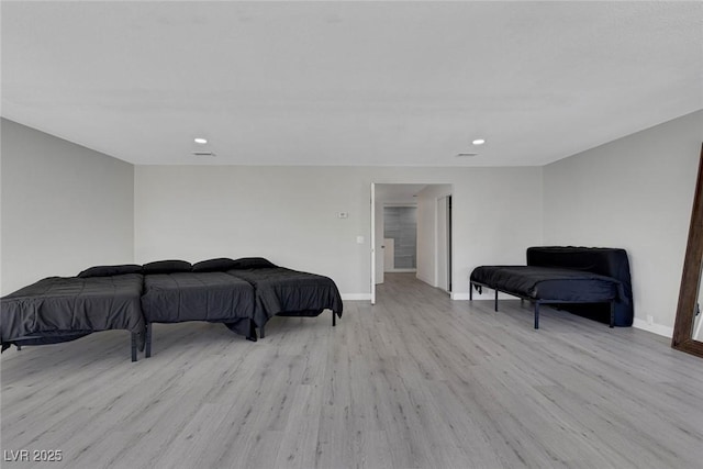 bedroom with recessed lighting, wood finished floors, and baseboards