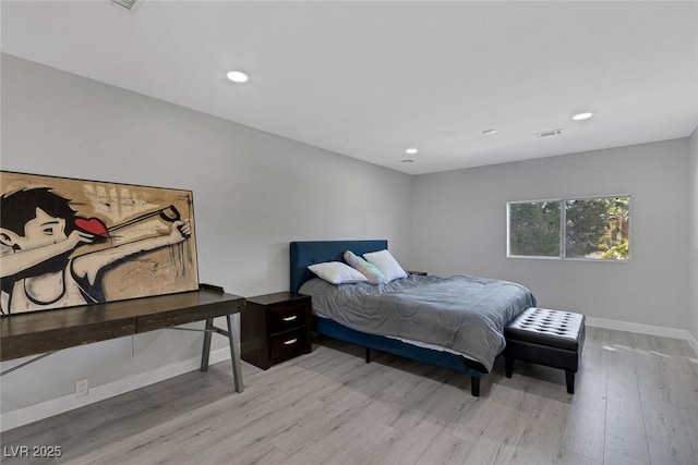 bedroom with recessed lighting, wood finished floors, visible vents, and baseboards