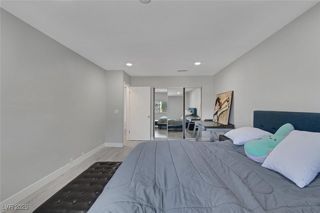 bedroom featuring recessed lighting, wood finished floors, a closet, and baseboards