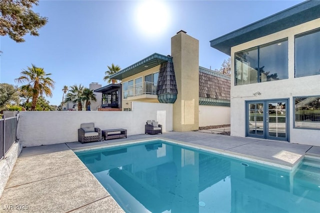 back of house featuring a fenced in pool, a patio, a chimney, and fence