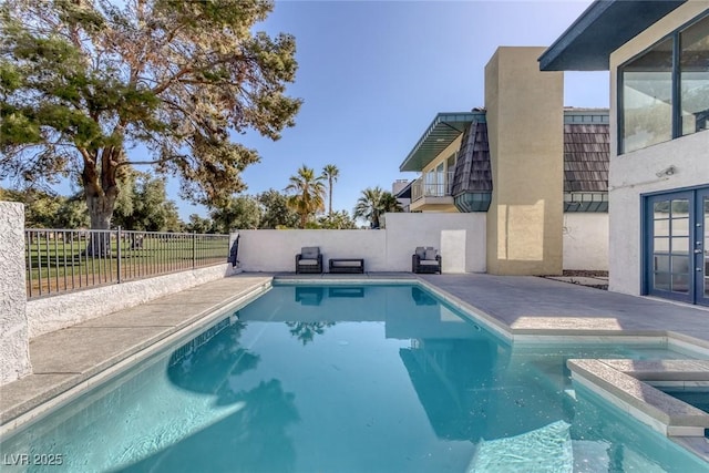 view of pool with a fenced backyard, a fenced in pool, and an in ground hot tub
