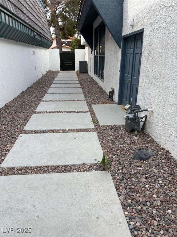 view of yard with fence, a gate, and central air condition unit