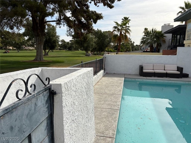 view of swimming pool featuring a lawn, fence, and a fenced in pool