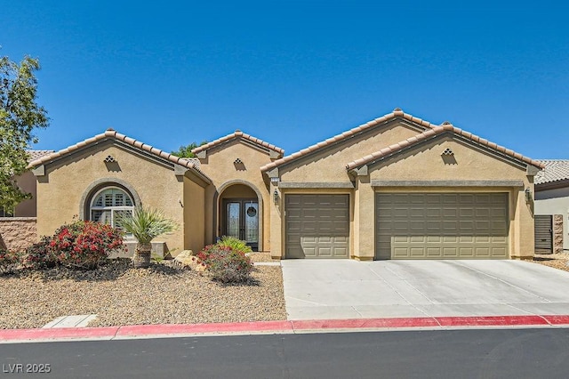 7513 Java Sparrow St, North Las Vegas, NV 89084 - mediterranean / spanish house featuring a garage, driveway, a tiled roof, and stucco siding