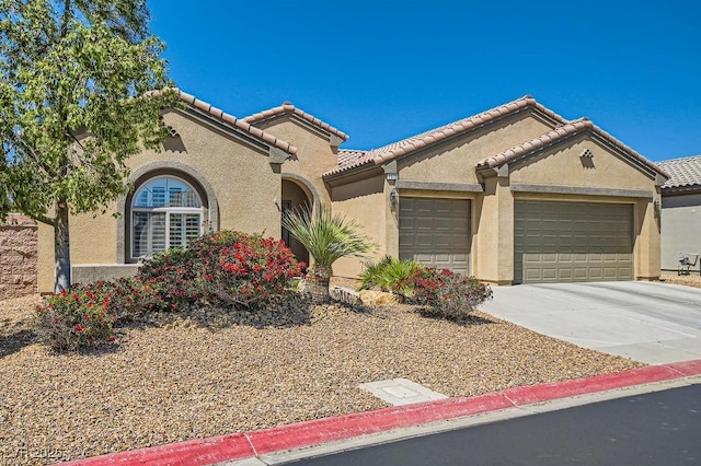 7513 Java Sparrow St, North Las Vegas, NV 89084 - mediterranean / spanish-style home featuring stucco siding, driveway, a tiled roof, and a garage