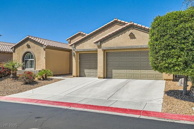 7513 Java Sparrow St, North Las Vegas, NV 89084 - mediterranean / spanish house with a garage, driveway, a tiled roof, and stucco siding