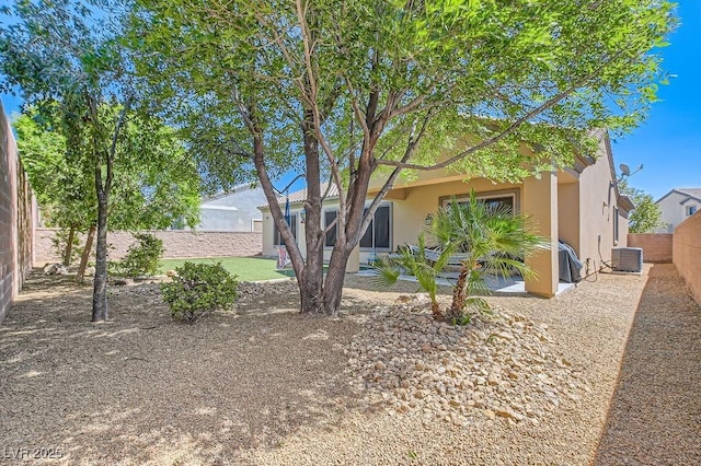 7513 Java Sparrow St, North Las Vegas, NV 89084 - view of front of home with a patio area, a fenced backyard, central AC unit, and stucco siding