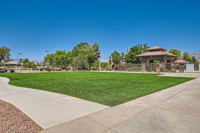 7513 Java Sparrow St, North Las Vegas, NV 89084 - surrounding community with a gazebo, a yard, fence, and a gate