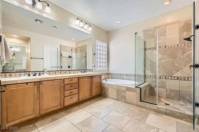 7513 Java Sparrow St, North Las Vegas, NV 89084 - bathroom with double vanity, a garden tub, a stall shower, and a sink