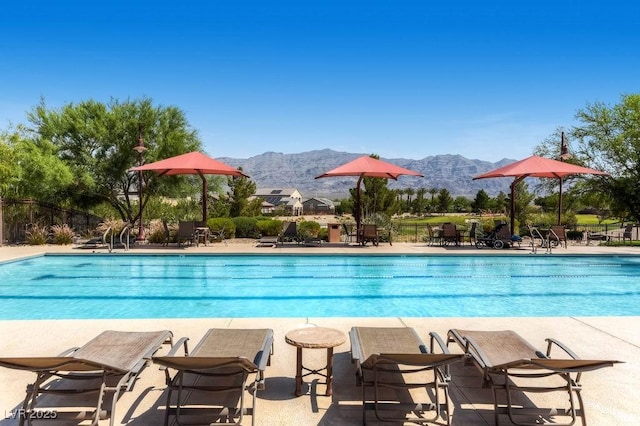 7513 Java Sparrow St, North Las Vegas, NV 89084 - community pool featuring a patio area, fence, and a mountain view