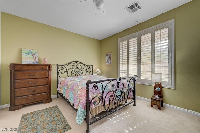 bedroom featuring light carpet, a ceiling fan, visible vents, and baseboards