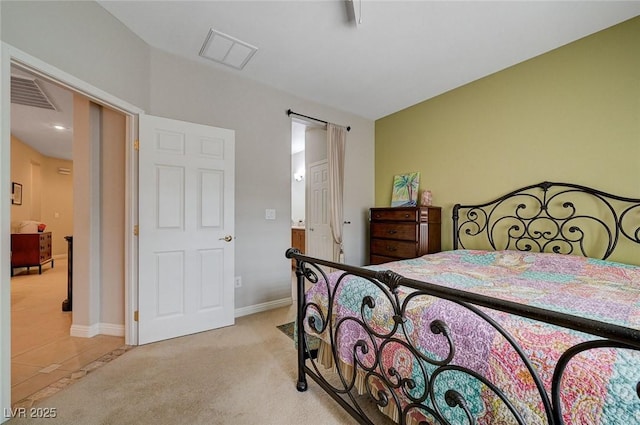 bedroom featuring baseboards, visible vents, light colored carpet, and light tile patterned floors