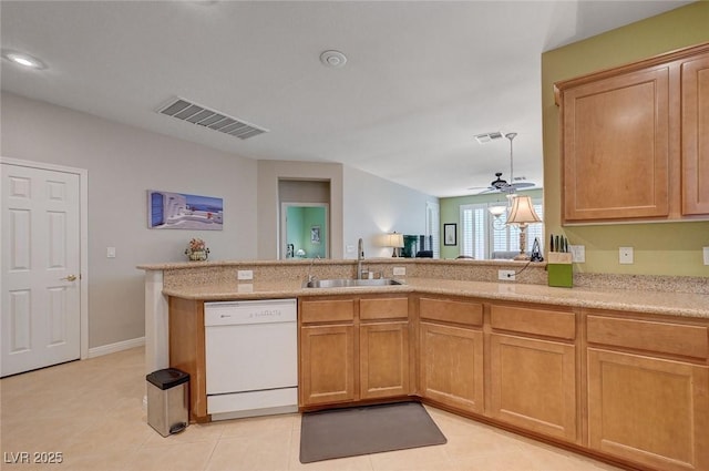 kitchen with a sink, visible vents, white dishwasher, a ceiling fan, and light tile patterned floors