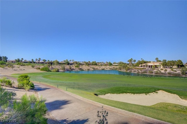 view of property's community featuring a lawn, a water view, and golf course view
