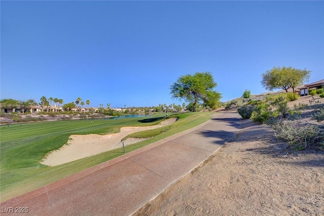 view of road featuring view of golf course and a water view