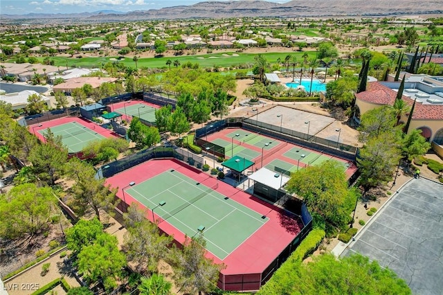 aerial view featuring view of golf course, a mountain view, and a residential view