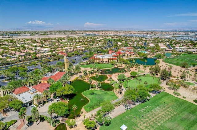 aerial view with golf course view, a water view, and a residential view