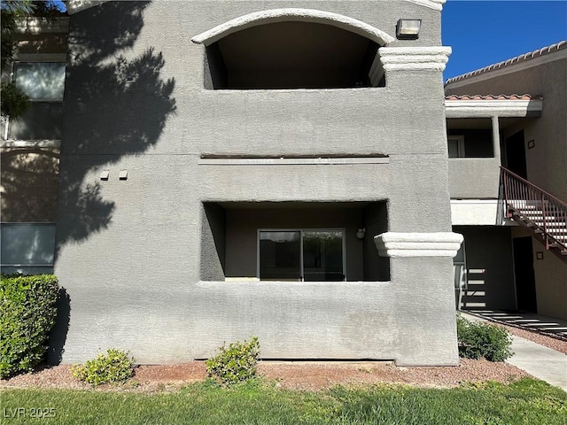 5055 W Hacienda Ave Unit 1095, Las Vegas, NV 89118 - exterior space featuring stucco siding and stairs