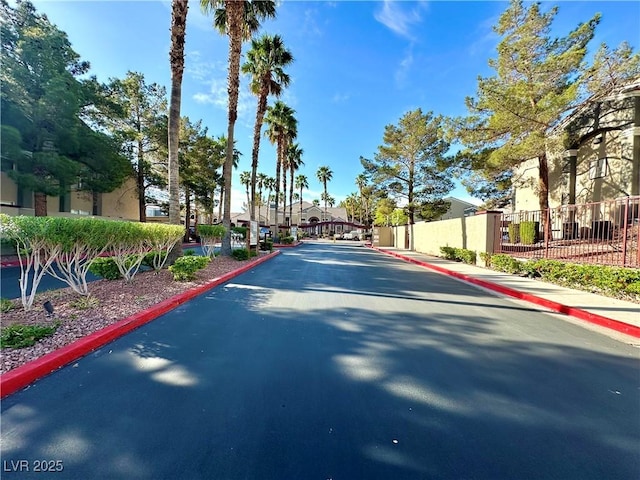 5055 W Hacienda Ave Unit 1095, Las Vegas, NV 89118 - view of road with a gated entry, curbs, and sidewalks
