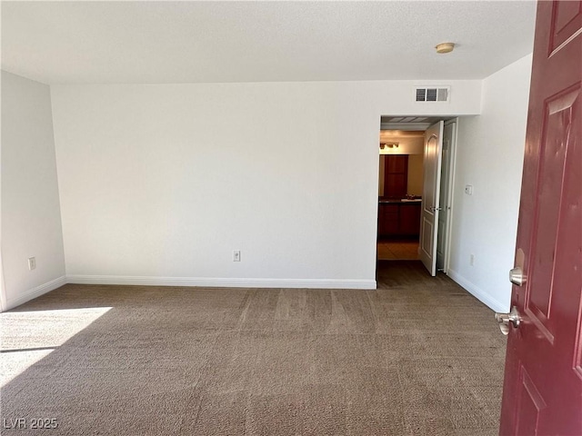 5055 W Hacienda Ave Unit 1095, Las Vegas, NV 89118 - empty room featuring carpet floors, visible vents, and baseboards