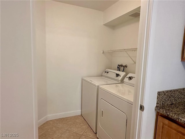 5055 W Hacienda Ave Unit 1095, Las Vegas, NV 89118 - washroom with baseboards, visible vents, washer and dryer, laundry area, and light tile patterned floors