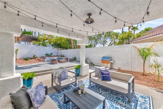 view of patio / terrace featuring a fenced backyard, an outdoor living space, and area for grilling