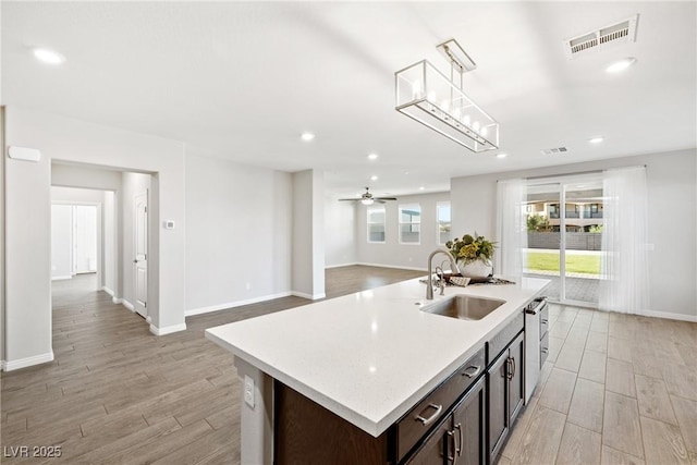 1512 Sagefield Way, Logandale, NV 89021 - kitchen with light countertops, recessed lighting, light wood-type flooring, pendant lighting, and open floor plan
