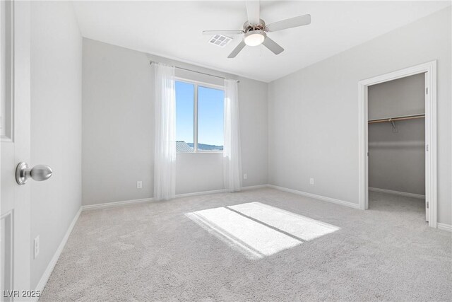 1512 Sagefield Way, Logandale, NV 89021 - unfurnished bedroom featuring carpet, a walk in closet, and ceiling fan